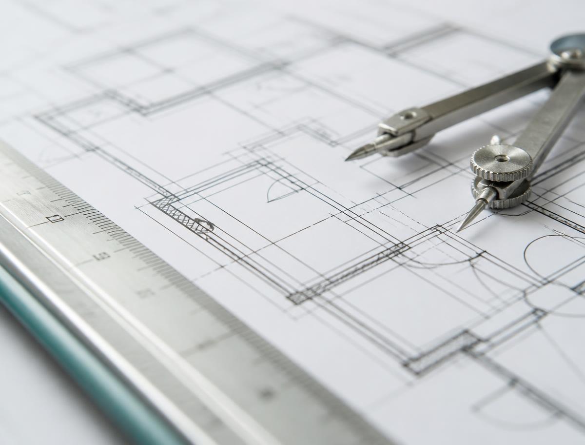 Dimensioned floor plan drawing with a scale rule and drafting compass